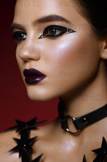 Beautiful girl with bright creative make-up and graphic arrows. Beauty face. Photos shot in studio