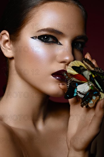 Beautiful girl with bright creative make-up and graphic arrows. Beauty face. Photos shot in studio