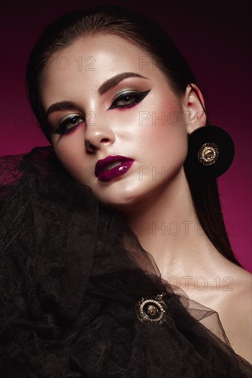 Beautiful girl with bright creative make-up and graphic arrows. Beauty face. Photos shot in studio
