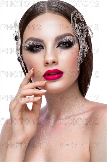 Beautiful girl with creative art make-up and silver accessories. Beauty face. Photos shot in studio