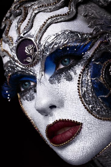 Portrait of a girl with creative art make-up. Unusual image. Photo taken in the studio