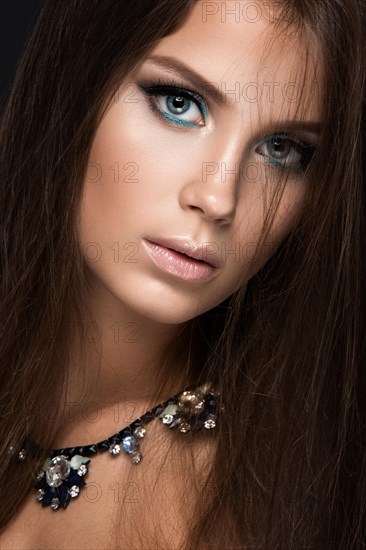 Beautiful woman with evening make-up and long straight hair