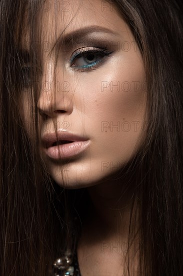 Beautiful woman with evening make-up and long straight hair