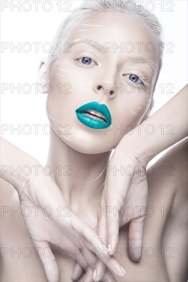 Beautiful girl in the image of albino with blue lips and white eyes. Art beauty face. Picture taken in the studio on a white background