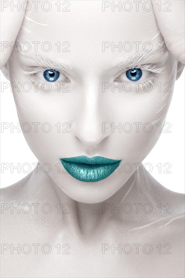 Beautiful girl in the image of albino with blue lips and white eyes. Art beauty face. Picture taken in the studio on a white background