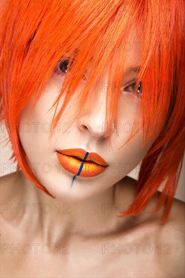Beautiful girl in an orange wig cosplay style with bright creative lips. Art beauty image. Portrait shot in the studio