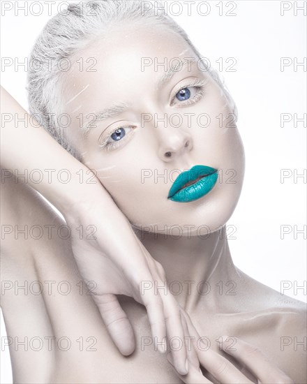 Beautiful girl in the image of albino with blue lips and white eyes. Art beauty face. Picture taken in the studio on a white background