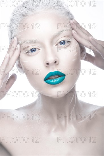 Beautiful girl in the image of albino with blue lips and white eyes. Art beauty face. Picture taken in the studio on a white background