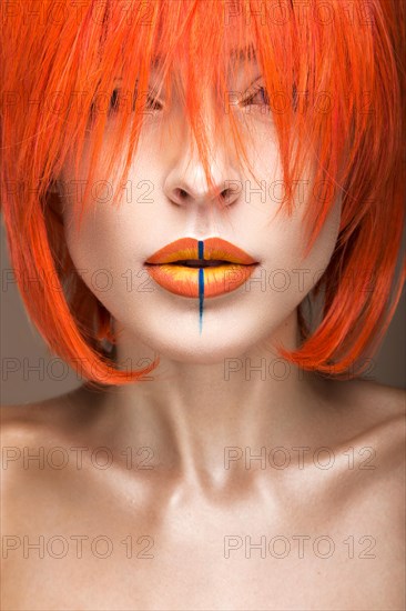 Beautiful girl in an orange wig cosplay style with bright creative lips. Art beauty image. Portrait shot in the studio