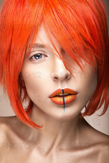 Beautiful girl in an orange wig cosplay style with bright creative lips. Art beauty image. Portrait shot in the studio