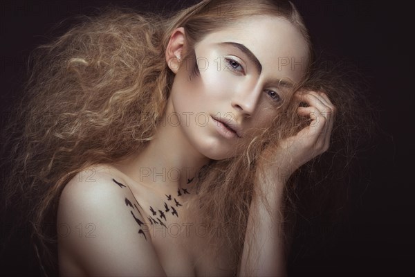 Beautiful girl with a pattern on the body in the form of birds