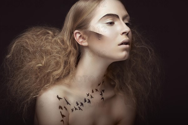 Beautiful girl with a pattern on the body in the form of birds