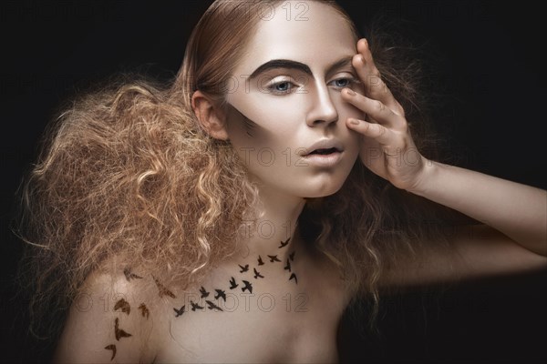 Beautiful girl with a pattern on the body in the form of birds