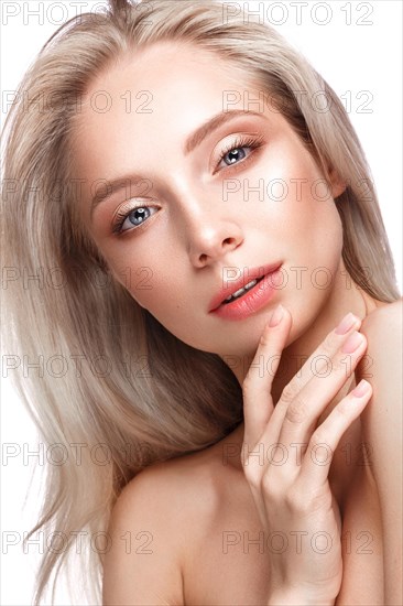 Beautiful young girl with a light natural make-up and perfect skin. Beauty face. Picture taken in the studio on a white background