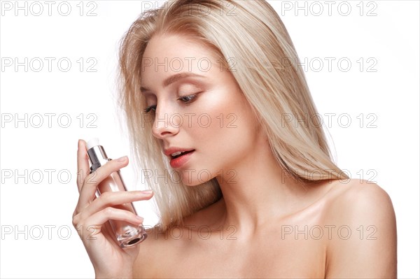 Beautiful girl with natural make-up with foundation in hands. Beauty face. Picture taken in the studio on a white background