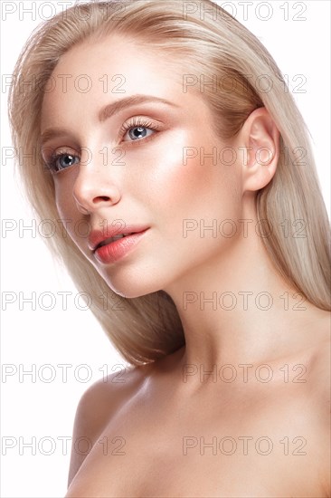 Beautiful young girl with a light natural make-up and perfect skin. Beauty face. Picture taken in the studio on a white background