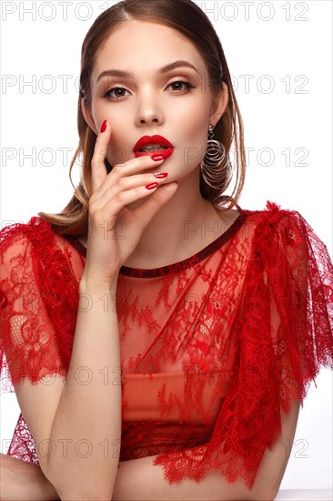 Beautiful girl in red dress with classic make-up and red manicure. Beauty face. Photo taken in the studio