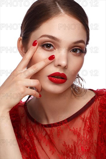 Beautiful girl in red dress with classic make-up and red manicure. Beauty face. Photo taken in the studio