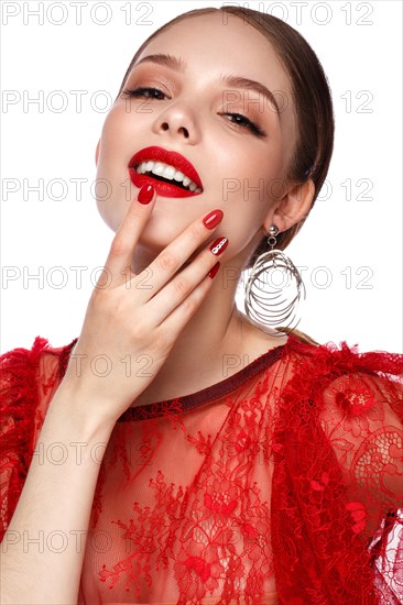 Beautiful girl in red dress with classic make-up and red manicure. Beauty face. Photo taken in the studio