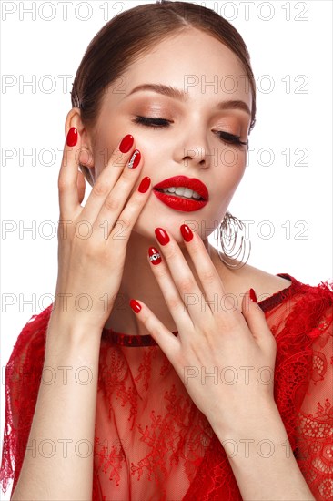 Beautiful girl in red dress with classic make-up and red manicure. Beauty face. Photo taken in the studio