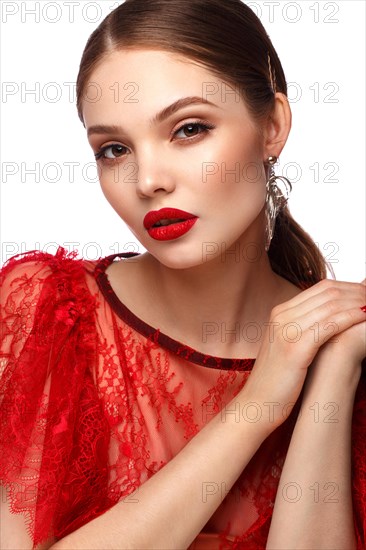 Beautiful girl in red dress with classic make-up and red manicure. Beauty face. Photo taken in the studio