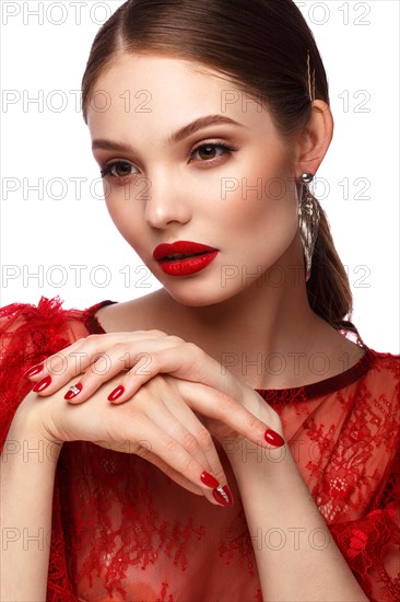 Beautiful girl in red dress with classic make-up and red manicure. Beauty face. Photo taken in the studio