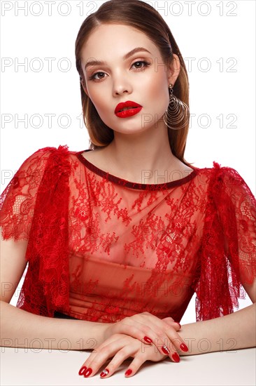 Beautiful girl in red dress with classic make-up and red manicure. Beauty face. Photo taken in the studio