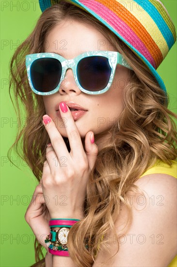 Bright cheerful girl in a summer hat