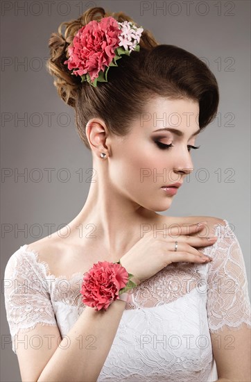 Portrait of a beautiful woman in the image of the bride with flowers in her hair. Picture taken in the studio on a black background
