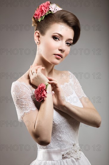 Portrait of a beautiful woman in the image of the bride with flowers in her hair. Picture taken in the studio on a black background