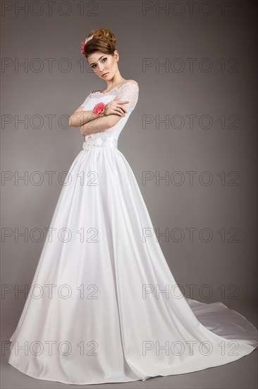 Portrait of a beautiful woman in the image of the bride with flowers in her hair. Picture taken in the studio on a black background