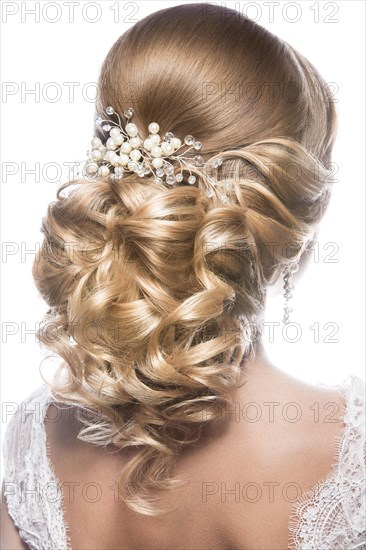 Portrait of a beautiful woman in image of the bride. Picture taken in the studio on a black background. Beauty hair. Hairstyle back view