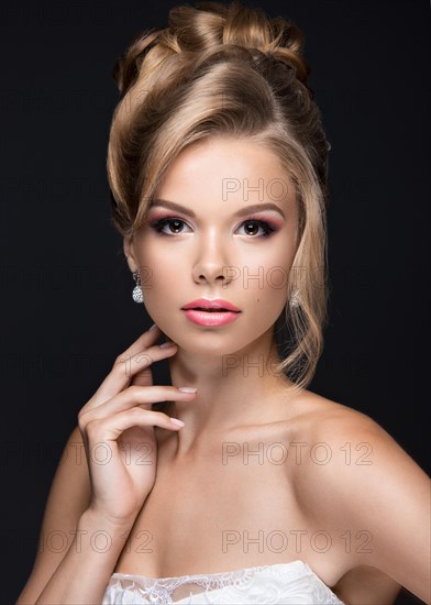 Portrait of a beautiful blond woman in the image of the bride. Picture taken in the studio on a black background. Beauty face and Hairstyle