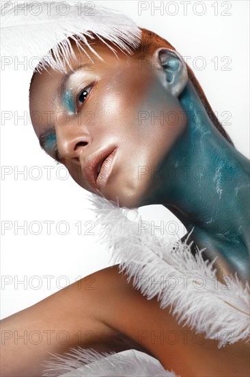 Portrait of a girl with gold and blue creative art make-up. Photo taken in the studio