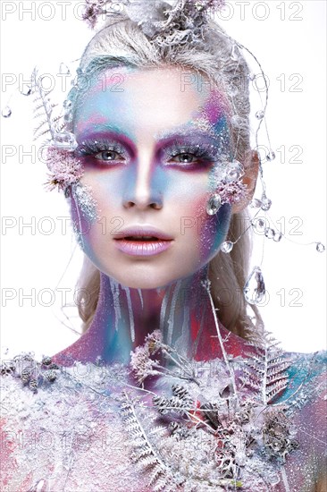 Beautiful girl in the image of a snowy unicorn creature. Creative make up. Art looks. Photo taken in the studio