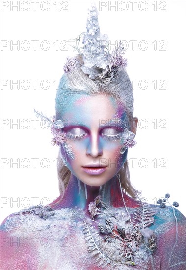 Beautiful girl in the image of a snowy unicorn creature. Creative make up. Art looks. Photo taken in the studio