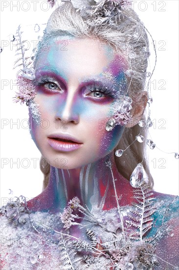 Beautiful girl in the image of a snowy unicorn creature. Creative make up. Art looks. Photo taken in the studio