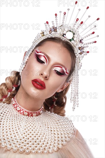Beautiful woman in a creative style with bright makeup and white clothes and accessories