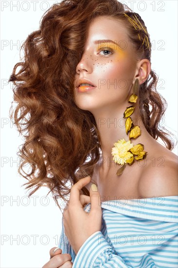 Portrait of beautiful red-haired girl with brightly colored art makeup and curls. Beauty face. Photo taken in the studio