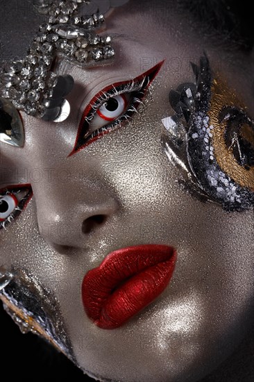 Portrait of a girl with creative art make-up. Unusual image. Photo taken in the studio