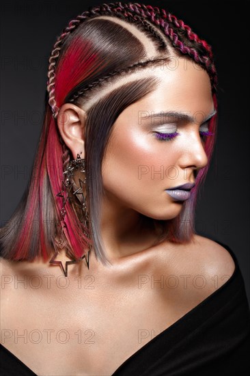 Beautiful girl with multi-colored hair and creative make-up and hairstyle. Beauty face. Photo taken in the studio