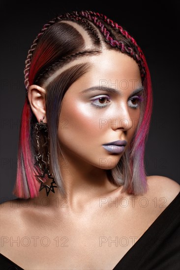 Beautiful girl with multi-colored hair and creative make-up and hairstyle. Beauty face. Photo taken in the studio