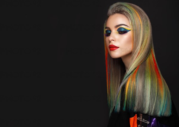 Beautiful girl with multi-colored hair and creative make-up and hairstyle. Beauty face. Photo taken in the studio