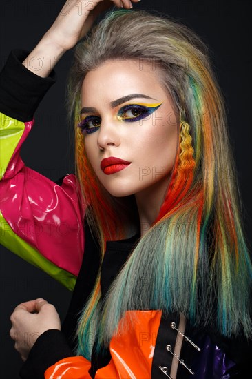 Beautiful girl with multi-colored hair and creative make-up and hairstyle. Beauty face. Photo taken in the studio