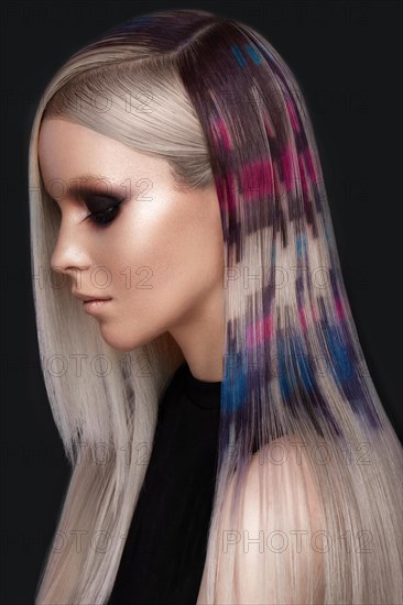 Portrait of beautiful woman with multi-colored hair and creative make up and hairstyle