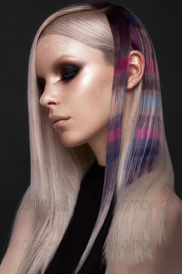 Portrait of beautiful woman with multi-colored hair and creative make up and hairstyle