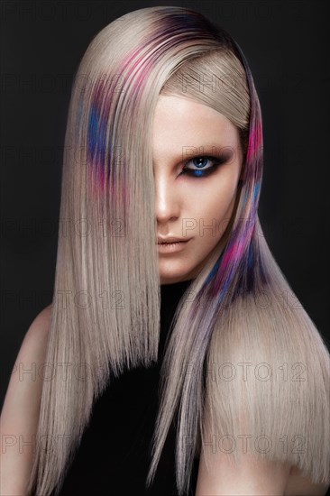 Portrait of beautiful woman with multi-colored hair and creative make up and hairstyle