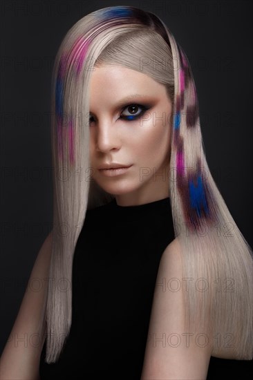 Portrait of beautiful woman with multi-colored hair and creative make up and hairstyle