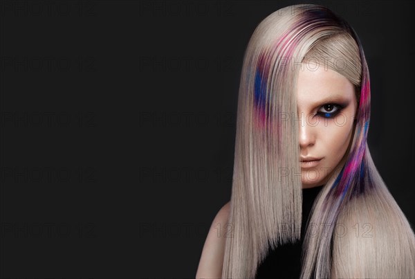 Portrait of beautiful woman with multi-colored hair and creative make up and hairstyle