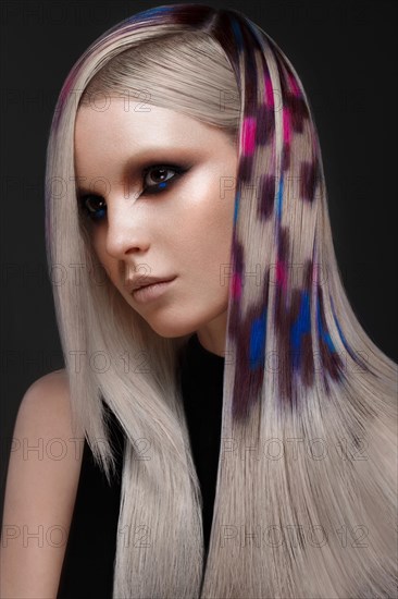 Portrait of beautiful woman with multi-colored hair and creative make up and hairstyle